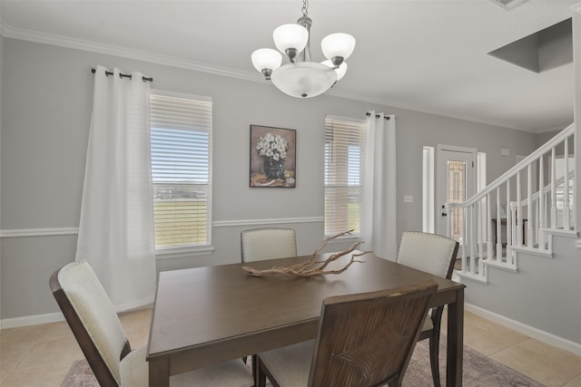 tiled dining area with ornamental molding and an inviting chandelier