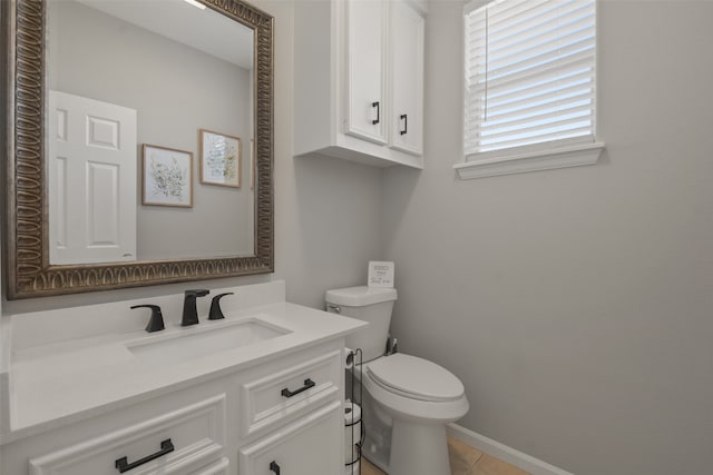 bathroom with vanity, toilet, and tile patterned flooring