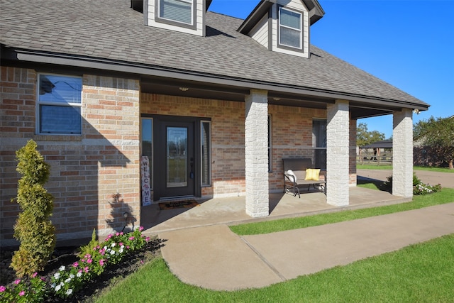 view of exterior entry with a patio