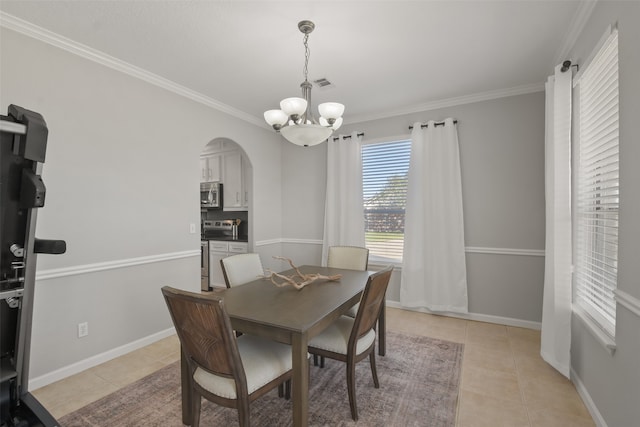 tiled dining area with a notable chandelier and ornamental molding