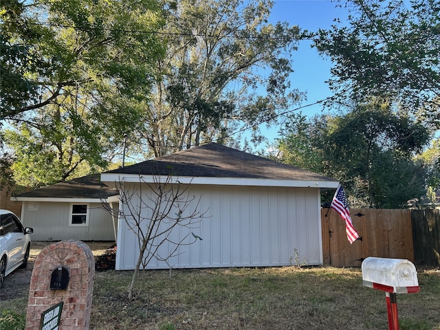 view of side of property featuring an outbuilding