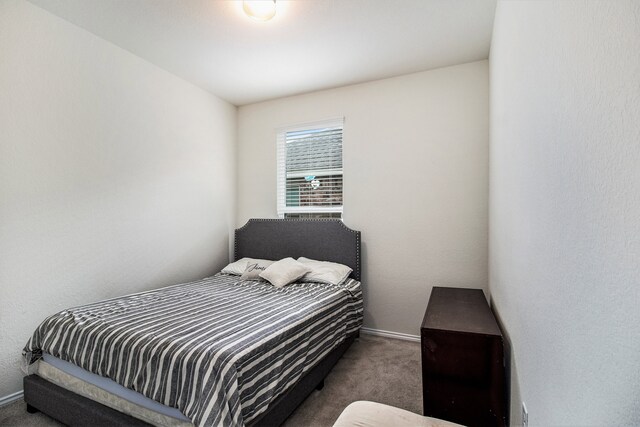 bedroom featuring dark colored carpet