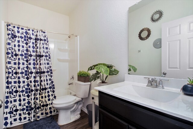 bathroom with vanity, toilet, hardwood / wood-style flooring, and a shower with shower curtain