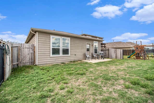 rear view of house featuring a patio, a playground, and a lawn