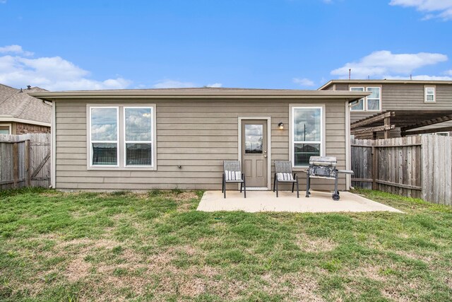 back of house featuring a yard and a patio