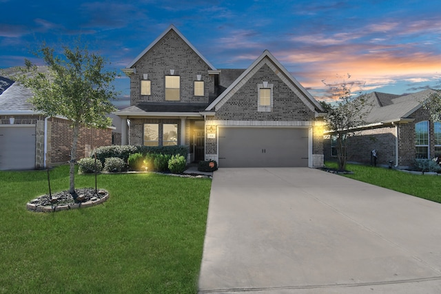 view of front of home with a yard and a garage