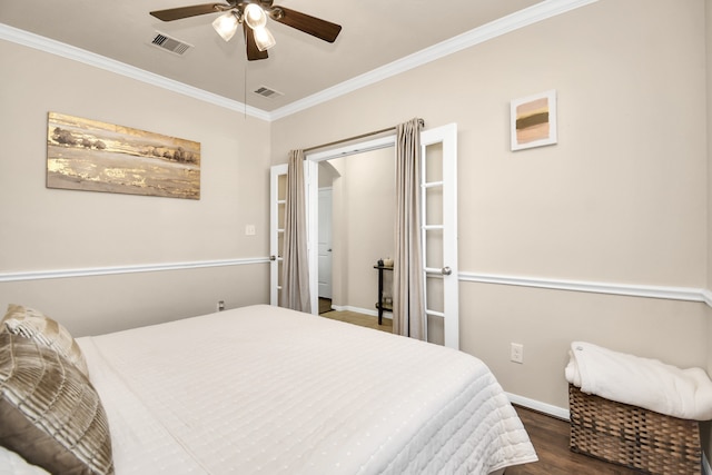 bedroom featuring ornamental molding, dark wood-type flooring, and ceiling fan