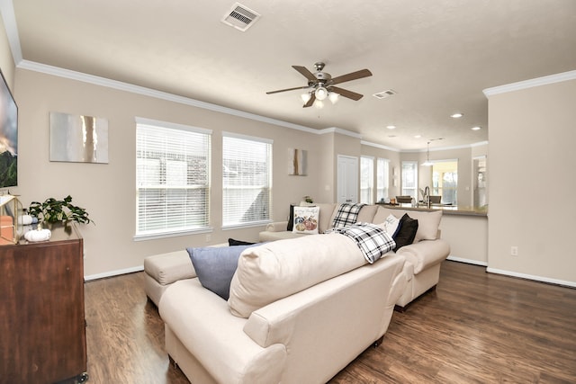 living room featuring hardwood / wood-style floors, crown molding, and ceiling fan