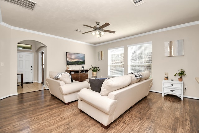 living room with ceiling fan, wood-type flooring, and ornamental molding