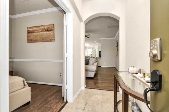 hall featuring light hardwood / wood-style floors and crown molding