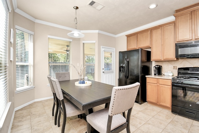 kitchen featuring hanging light fixtures, ornamental molding, black appliances, light tile patterned floors, and tasteful backsplash