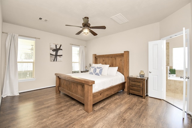 bedroom with dark wood-type flooring, ceiling fan, and connected bathroom