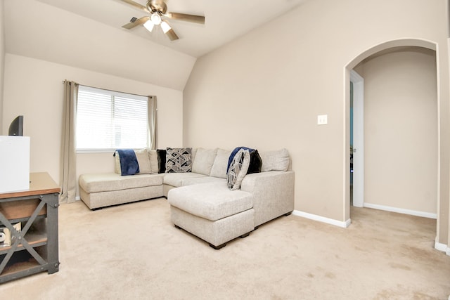 living room featuring carpet floors, ceiling fan, and vaulted ceiling