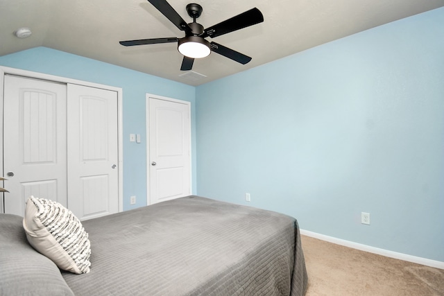 carpeted bedroom featuring lofted ceiling and ceiling fan