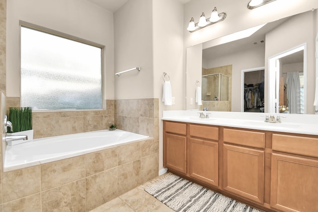 bathroom featuring a wealth of natural light, vanity, independent shower and bath, and tile patterned flooring