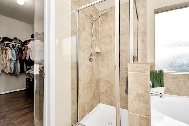 bathroom featuring a shower with shower door and hardwood / wood-style floors