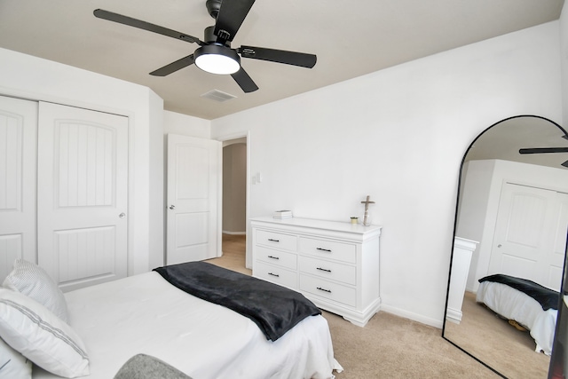 carpeted bedroom with a closet and ceiling fan