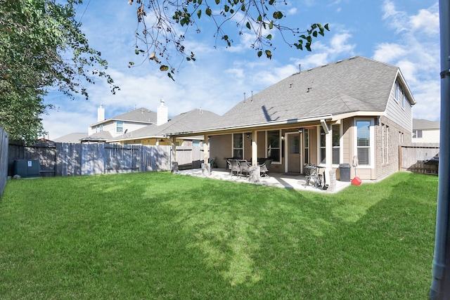 back of property featuring a patio and a lawn