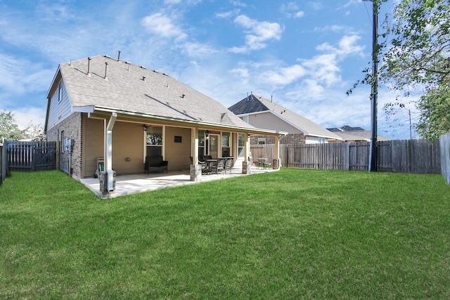 back of house featuring a yard and a patio area