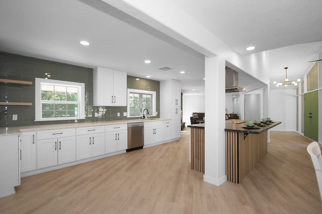 kitchen featuring dishwasher, backsplash, sink, light hardwood / wood-style flooring, and white cabinetry