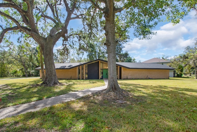 view of side of home with a yard