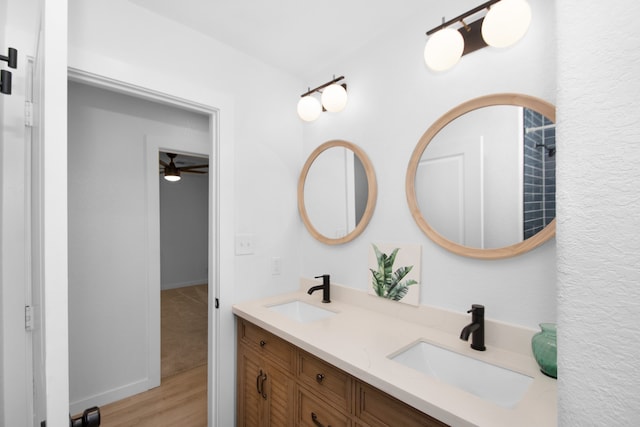 bathroom with hardwood / wood-style floors, vanity, and ceiling fan