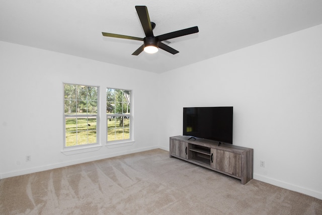 unfurnished living room featuring ceiling fan and light carpet