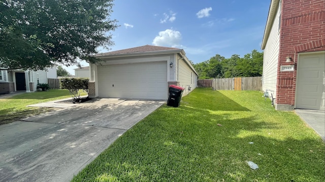 view of side of home with a lawn and a garage