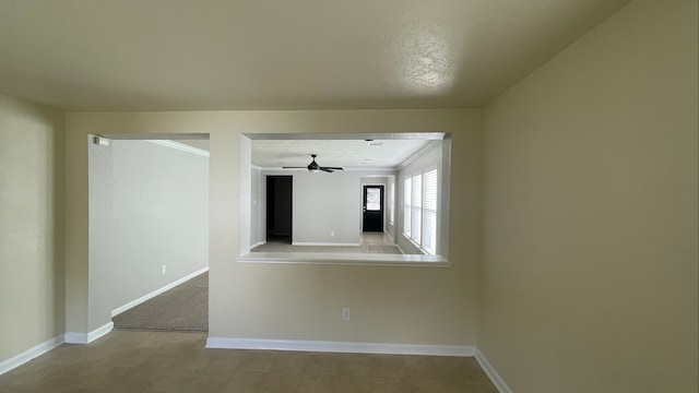 empty room with crown molding, a textured ceiling, and ceiling fan