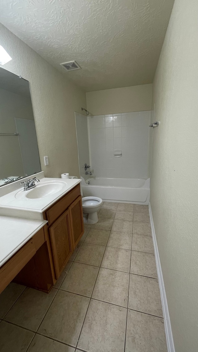 full bathroom featuring vanity, a textured ceiling, toilet, and tile patterned floors