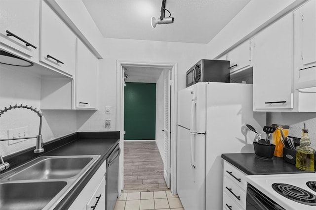 kitchen with white cabinets, stainless steel dishwasher, light wood-type flooring, electric stove, and sink