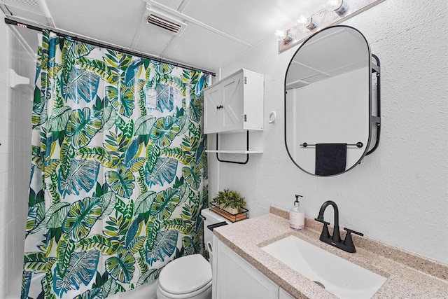 bathroom with vanity, a shower with curtain, and toilet