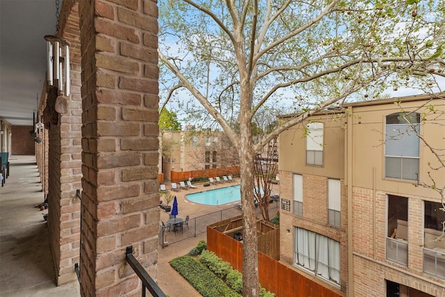 4643 Wild Indigo Unit 414, Houston, TX 77027 - view of property with a community pool and fence