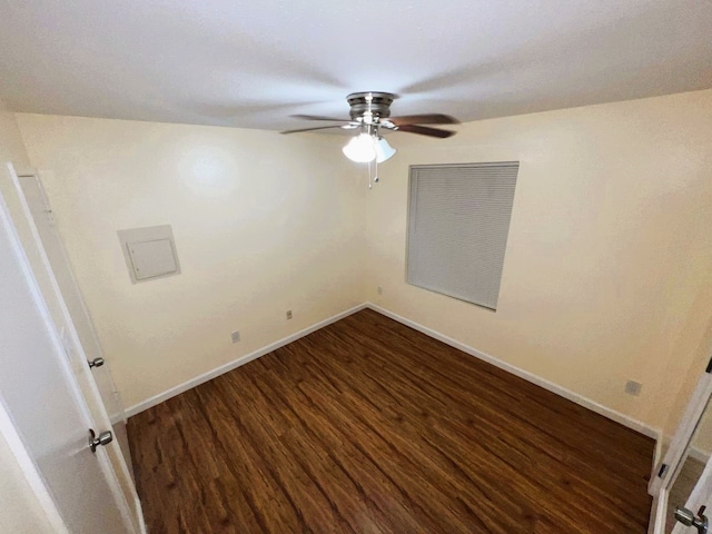 spare room with ceiling fan and dark hardwood / wood-style flooring