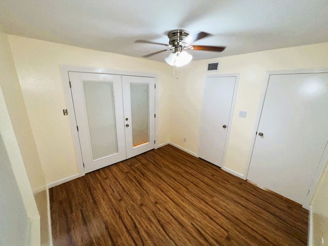 unfurnished bedroom with french doors, ceiling fan, and dark hardwood / wood-style floors