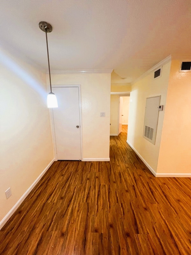 unfurnished room with crown molding and dark hardwood / wood-style floors