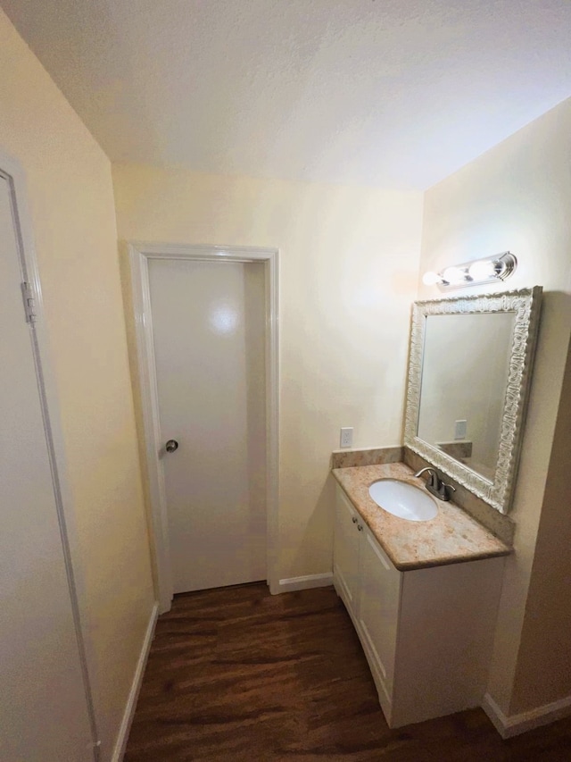 bathroom featuring vanity and hardwood / wood-style flooring