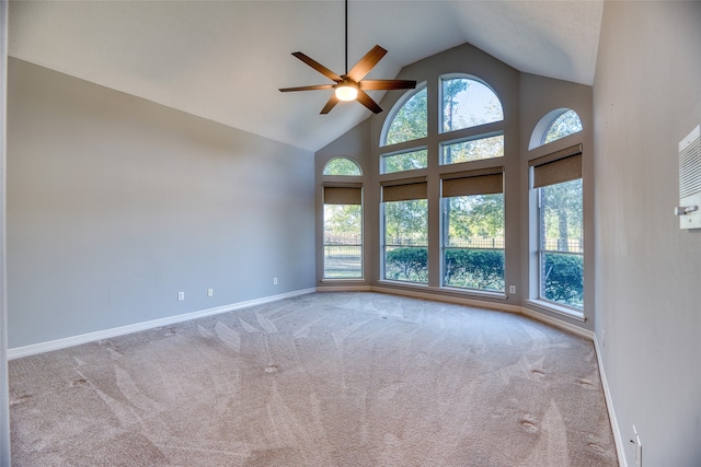 unfurnished room with light colored carpet, high vaulted ceiling, and ceiling fan