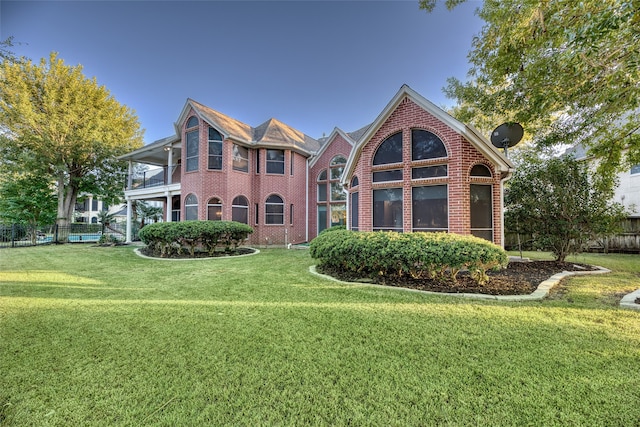 view of front property featuring a front lawn and a sunroom