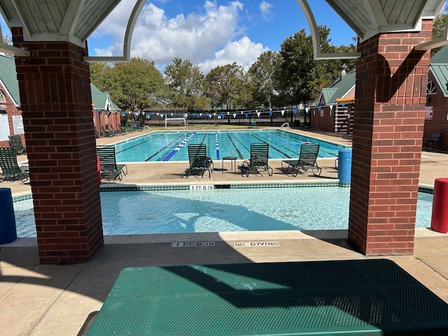 view of swimming pool featuring a patio area