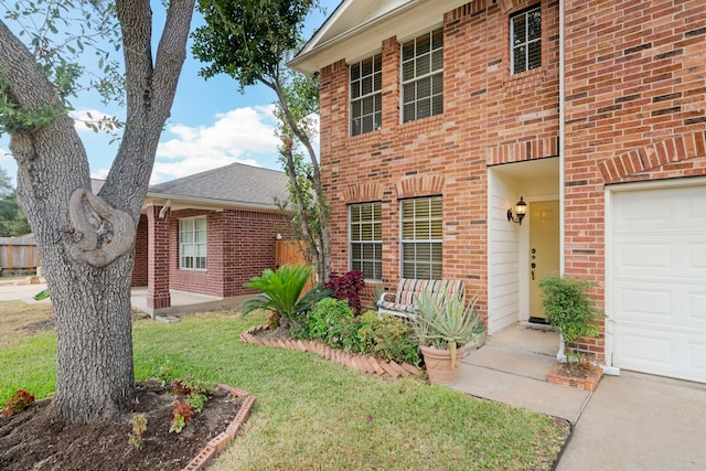 view of front of home with a front yard and a garage