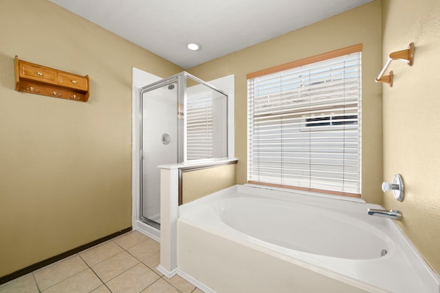 bathroom with separate shower and tub and tile patterned flooring