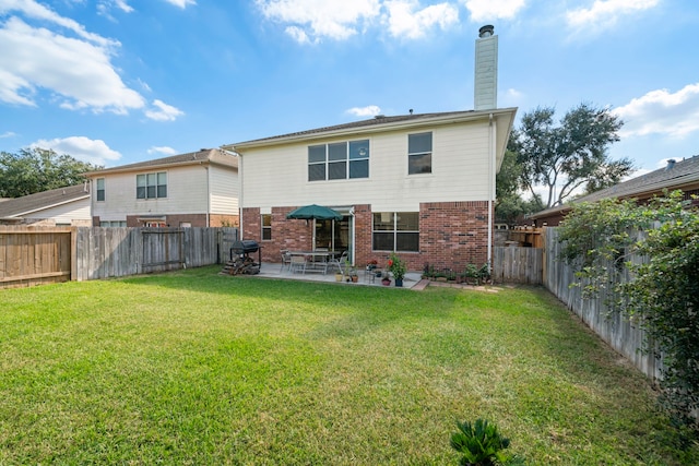 back of property featuring a patio and a lawn