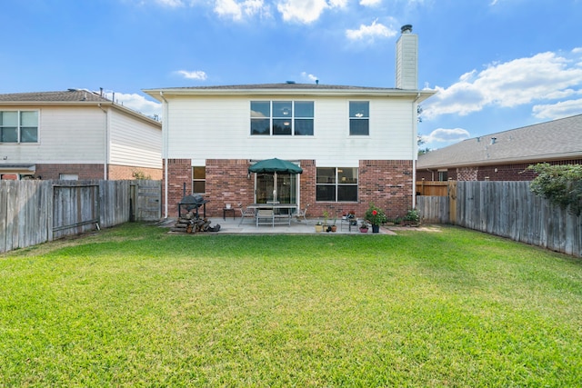 rear view of house featuring a patio and a yard