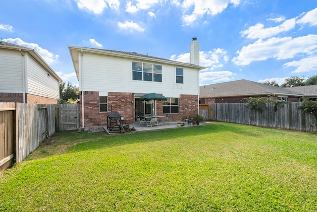 rear view of property with a patio area and a lawn