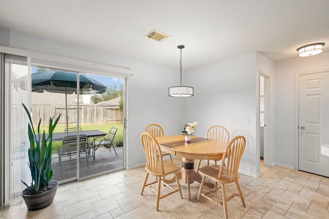 dining area with a textured ceiling