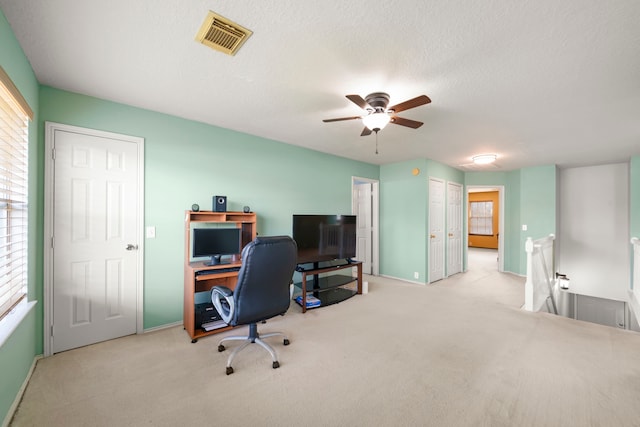 office with light carpet, a textured ceiling, and ceiling fan