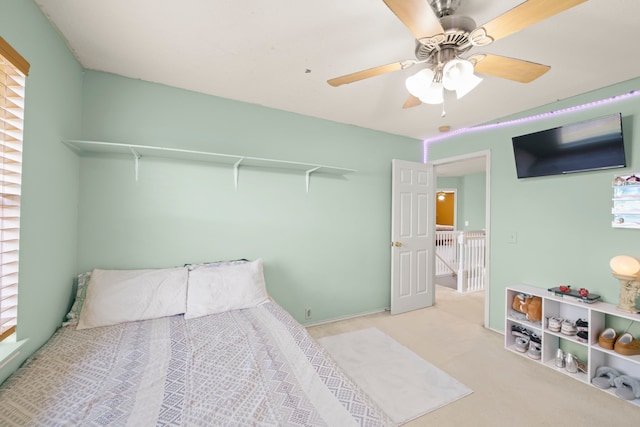 carpeted bedroom with multiple windows and ceiling fan