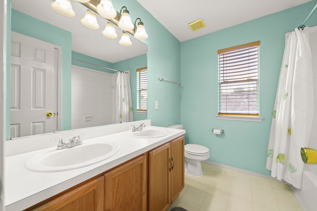 full bathroom featuring vanity, toilet, and shower / bath combination with curtain