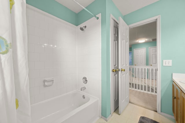 bathroom with vanity, shower / bath combo, and tile patterned flooring